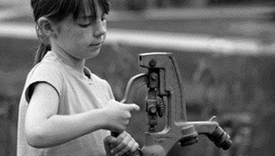 Photo Credit: girl using water pump image by sonya etchison from <a href='http://www.fotolia.com'>Fotolia.com</a> Like older hand pumps, electric ones have to be primed to work.