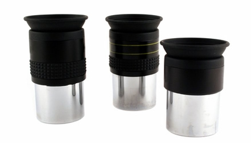 Photo Credit: Telescope 1.25 inch eyepieces image by Jim Mills from <a href='http://www.fotolia.com'>Fotolia.com</a> Eyepieces determine the magnifying power of your telescope.