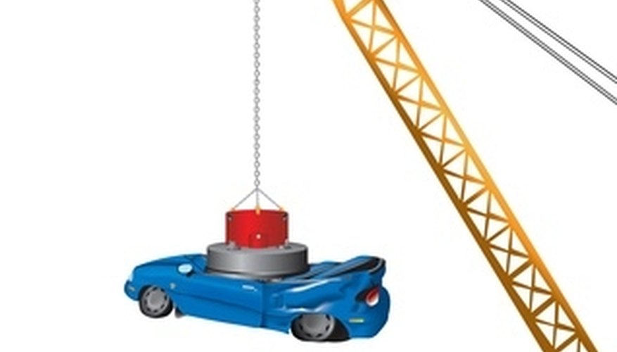 Photo Credit: crane image by Matthew Cole from <a href='http://www.fotolia.com'>Fotolia.com</a> There are two types of magnets, electromagnets and natural magnets.