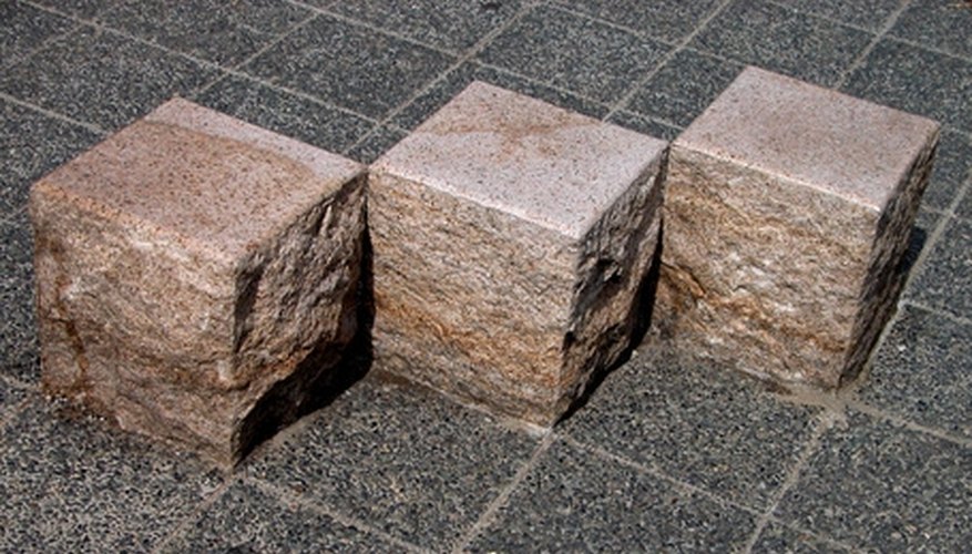 Photo Credit: cubic stones geometry image by Radu Razvan from <a href='http://www.fotolia.com'>Fotolia.com</a> You can calculate the volume of solid figures by using geometry.