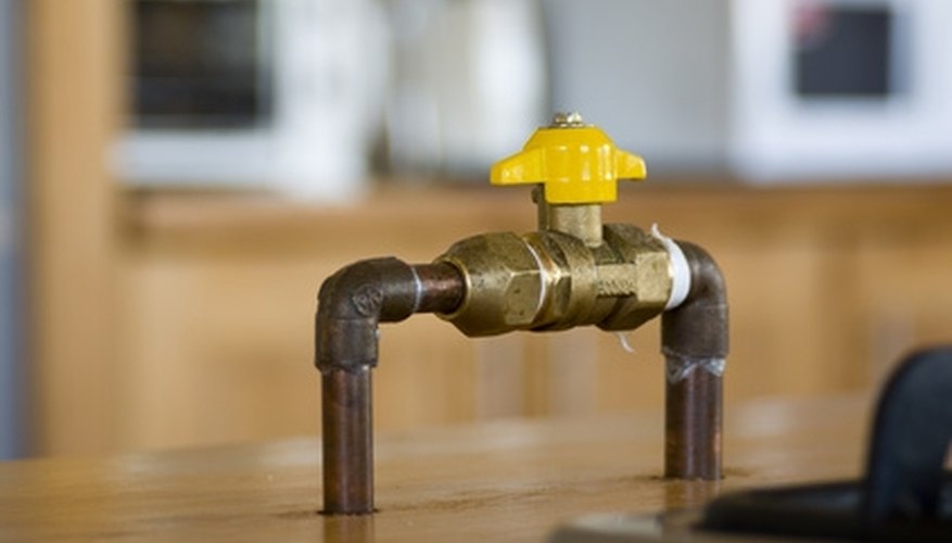 Photo Credit: gas shut-off valve image by enens from <a href='http://www.fotolia.com'>Fotolia.com</a> Learn how to properly tighten the pressure valve on your hot water tank.