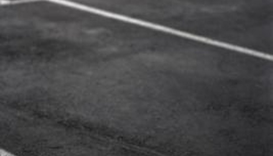 Photo Credit: Thinkstock/Comstock/Getty Images Sealcoat sprays can lengthen the life of your asphalt parking lot.