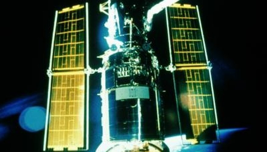 Photo Credit: Jupiterimages/Photos.com/Getty Images Solar cells power satellites in deep space.