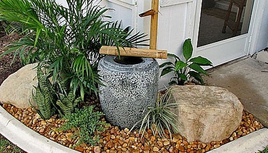 Pour the stones and add the bamboo fixture. Pour the stones and add the bamboo fixture.