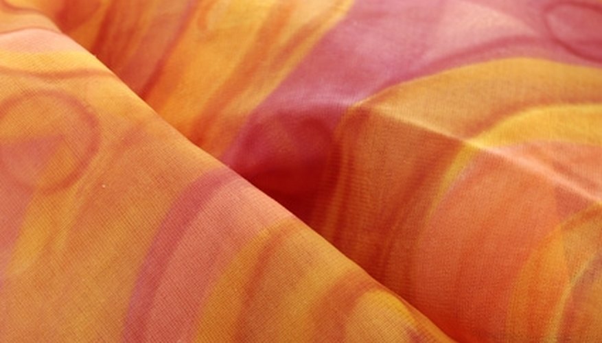 Photo Credit: clothes image by Zbigniew Nowak from <a href='http://www.fotolia.com'>Fotolia.com</a> Static electricity builds up in your clothes and can cause them to cling unflatteringly.