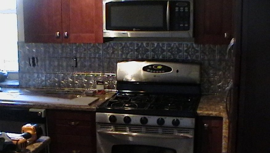 Faux tin is easy to clean and creates a stylish and sharp finish to your kitchen walls Faux tin is easy to clean and creates a stylish and sharp finish to your kitchen walls