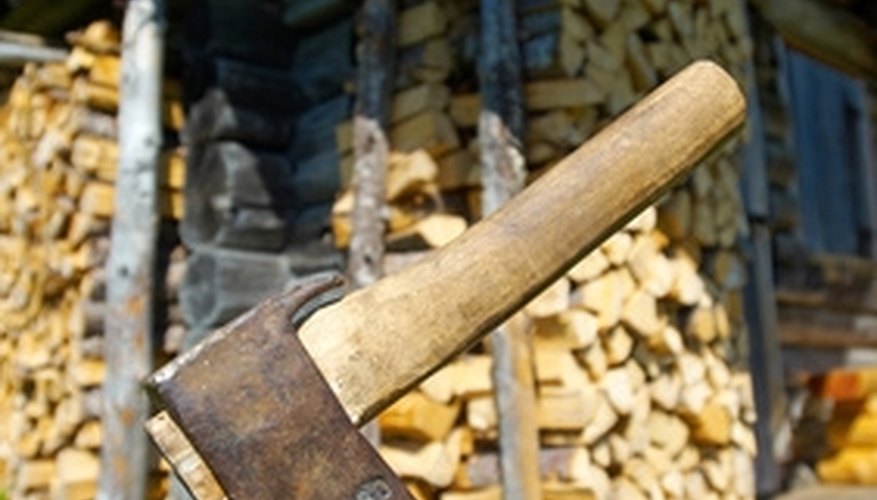 Use an axe or log splitter to cut logs efficiently. Use an axe or log splitter to cut logs efficiently.