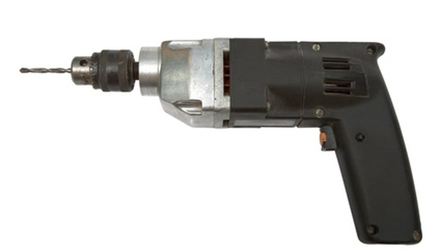 Use a portable drill to make holes for your wall anchors. Use a portable drill to make holes for your wall anchors.