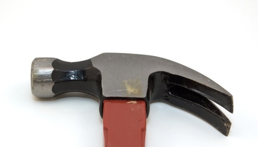 Use a hammer to gently tap in the wall anchors. Use a hammer to gently tap in the wall anchors.