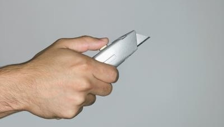 Use a utility knife to scrape away burrs from the PVC pipe. Use a utility knife to scrape away burrs from the PVC pipe.