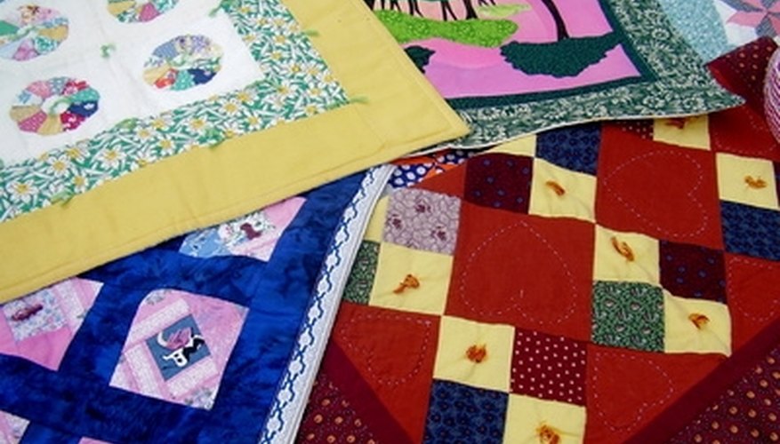 Choose a quilt or comforter for the bed. Choose a quilt or comforter for the bed.