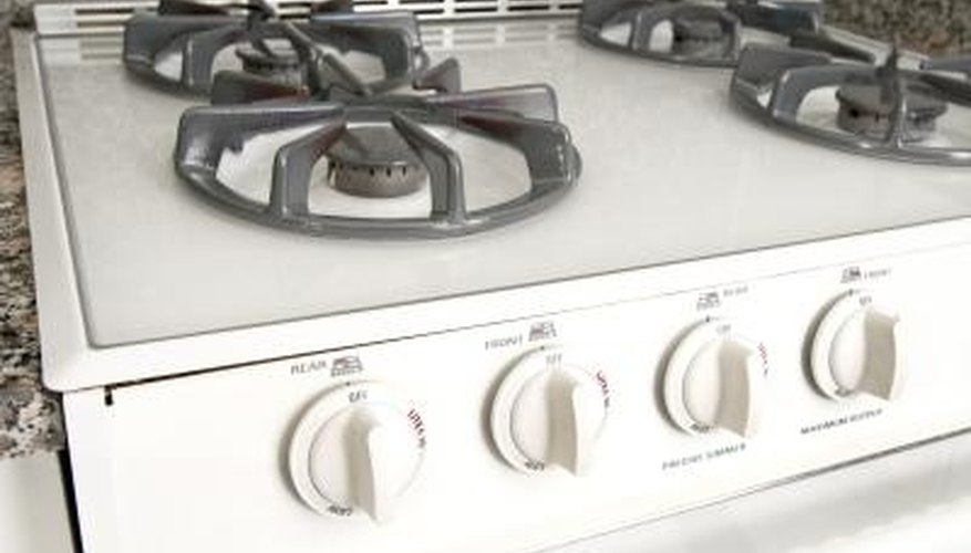 A slide-in gas range fits into a space between two cabinets. A slide-in gas range fits into a space between two cabinets.