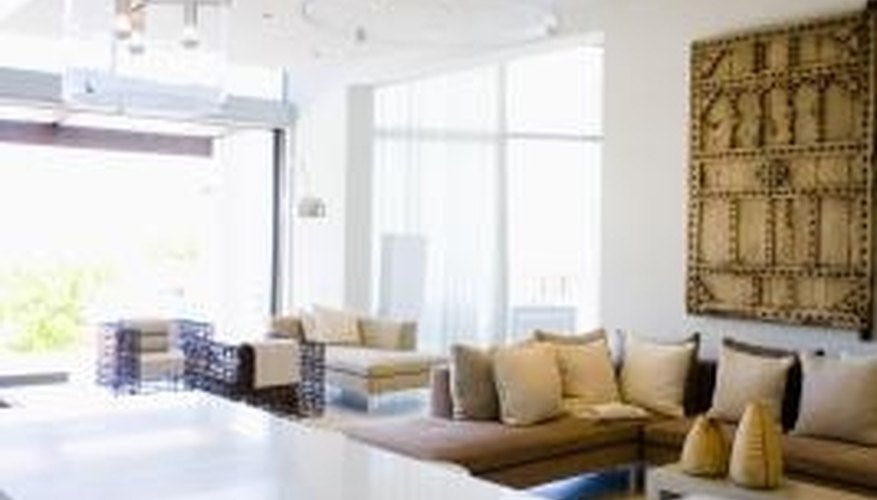 Multiple modern chandeliers are used over an island to provide good surface lighting. Multiple modern chandeliers are used over an island to provide good surface lighting.