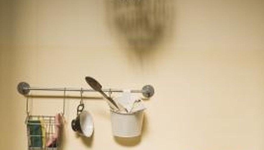 A small chandelier highlights a kitchen sink. A small chandelier highlights a kitchen sink.
