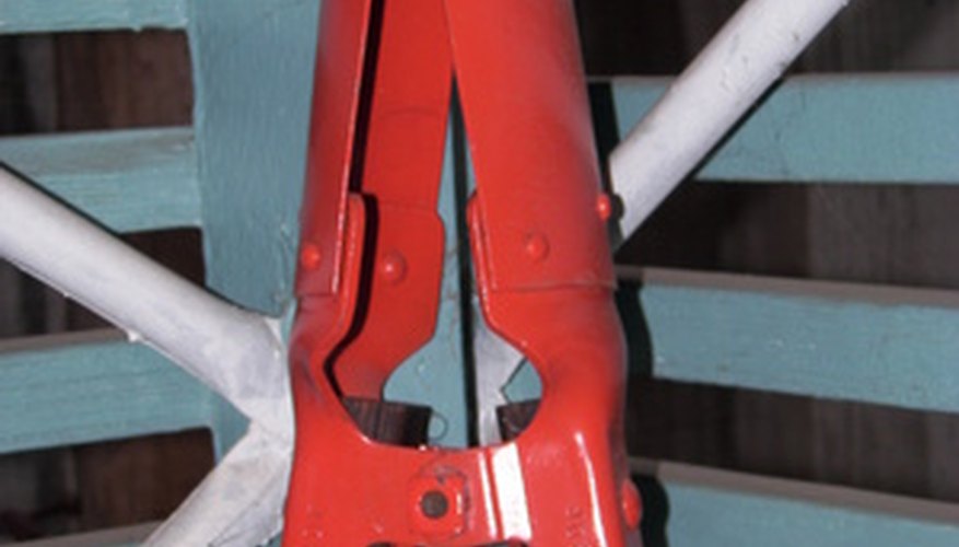 Photo Credit: post hole digger image by Joann Cooper from <a href='http://www.fotolia.com'>Fotolia.com</a> Dig the hole so that it is three times larger than the post.