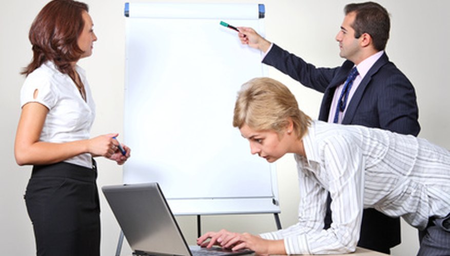 Photo Credit: Three office workers image by Vladimir Melnik from <a href='http://www.fotolia.com'>Fotolia.com</a> The arrangement of employees is an essential management function.