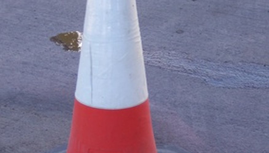 Photo Credit: road cone image by timur1970 from <a href='http://www.fotolia.com'>Fotolia.com</a> The volume of a cone is calculated using pi.