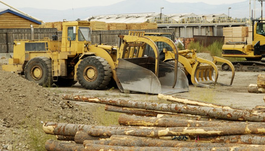 Photo Credit: logging equipment 3 image by Jim Parkin from <a href='http://www.fotolia.com'>Fotolia.com</a> Logging business facilities should accommodate large equipment storage.