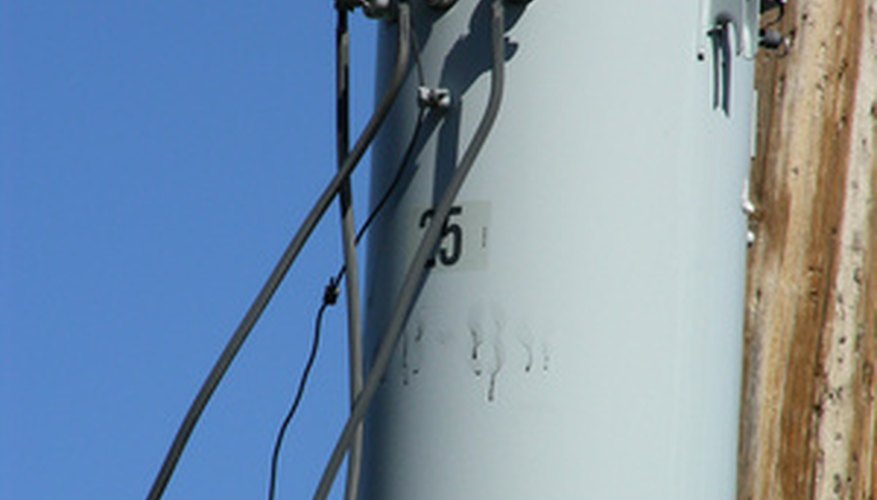 Photo Credit: transformed image by John Sfondilias from <a href='http://www.fotolia.com'>Fotolia.com</a> This transformer lowers street voltage to household-use voltage; therefore it will have more windings on its primary side than on its secondary.