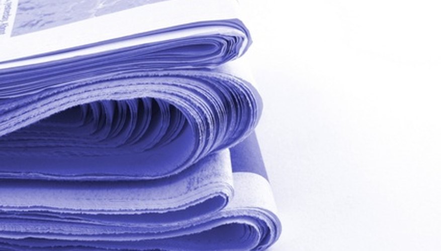 Photo Credit: newspapers image by Christopher Hall from <a href='http://www.fotolia.com'>Fotolia.com</a> Cover the table in old newspapers to protect your work space.