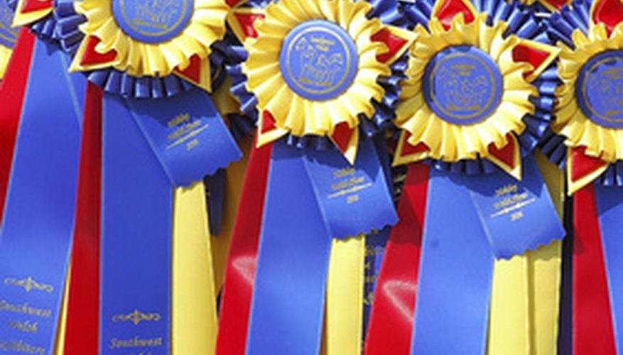Photo Credit: award ribbons image by Clarence Alford from <a href='http://www.fotolia.com'>Fotolia.com</a> Include important awards in your short bio.
