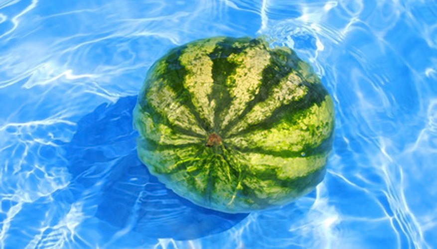 Photo Credit: Fresh water-melon in water image by Piter Pkruger from <a href='http://www.fotolia.com'>Fotolia.com</a> You can increase the density of water using temperature or salt.