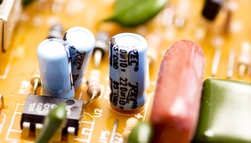 Photo Credit: computer circuit board image by Photosani from <a href='http://www.fotolia.com'>Fotolia.com</a> You can use a simple circuit board to charge a capacitor.