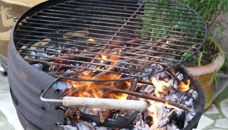 Photo Credit: barbecue image by Bruno Bernier from <a href='http://www.fotolia.com'>Fotolia.com</a> Heat distribution differs between cast iron and stainless steel grates.