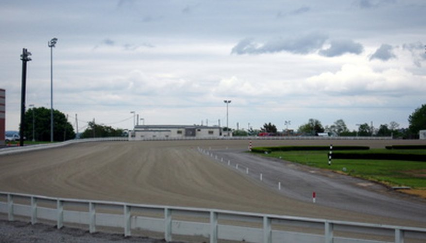 Photo Credit: yonkers racetrack image by Kenneth Summers from <a href='http://www.fotolia.com'>Fotolia.com</a> The inward slant of a racetrack is an applied use of centrifugal force.