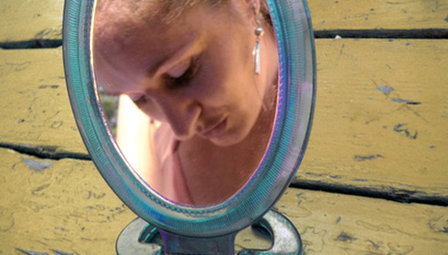 Photo Credit: mirror,mirror... image by Catabu from <a href='http://www.fotolia.com'>Fotolia.com</a> A concave mirror can magnify objects.