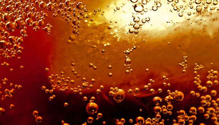 Photo Credit: Coca Cola auf Eis image by Andreas Bleul from <a href='http://www.fotolia.com'>Fotolia.com</a> Pop Rocks plus soda equals a soda geyser.