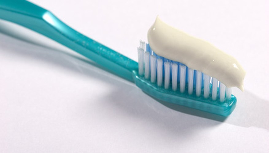 Photo Credit: tooth-brush image by AGphotographer from <a href='http://www.fotolia.com'>Fotolia.com</a> Swallowing toothpaste is discouraged, because too much fluoride can permanently stain teeth.