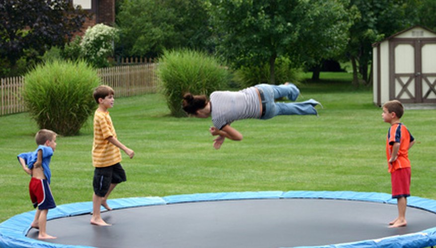 Photo Credit: kids jumping image by sonya etchison from <a href='http://www.fotolia.com'>Fotolia.com</a> As a science project, you can see how weight impacts bounce height on a trampoline.