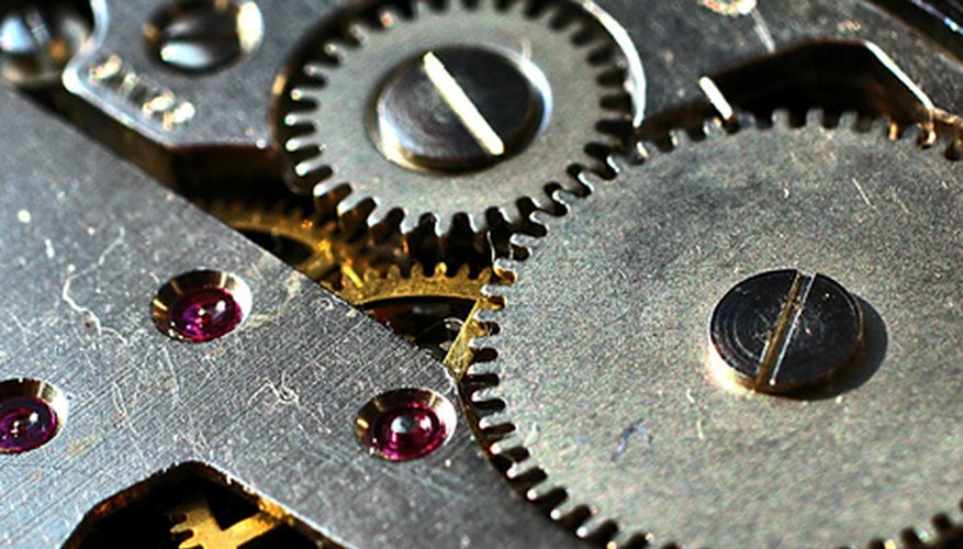Photo Credit: gears image by Stanisa Martinovic from <a href='http://www.fotolia.com'>Fotolia.com</a> A variety of materials are used to make gears and pulleys.