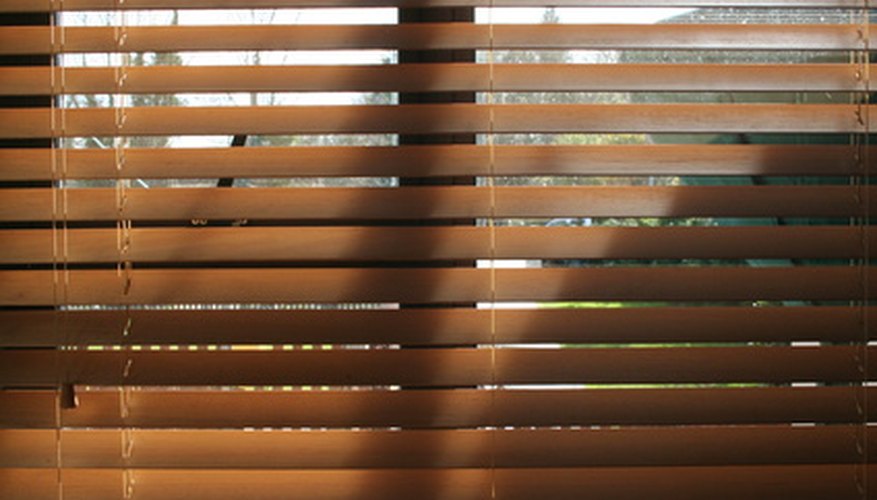 Photo Credit: venetian blind. image by guiney from <a href='http://www.fotolia.com'>Fotolia.com</a> The string running through these blinds is part of a pulley system.