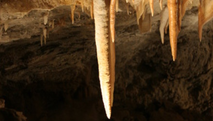 Photo Credit: cave,stalactite,stalagmite,rocks,rock formations, image by Earl Robbins from <a href='http://www.fotolia.com'>Fotolia.com</a> Stalagmites and stalactites result from mineral flows.