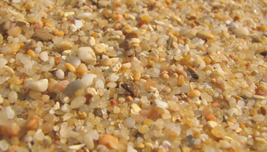 Photo Credit: beach sand close-up background image by kubais from <a href='http://www.fotolia.com'>Fotolia.com</a> Sand is made mostly of silica.