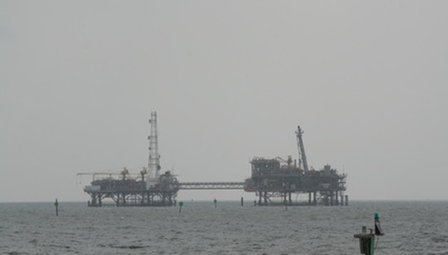 Photo Credit: oil platform image by michael langley from <a href='http://www.fotolia.com'>Fotolia.com</a> Oil rigs are often visible from the shores of gulf coast beaches in the United States.