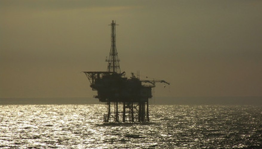 Photo Credit: oil rig at sunset image by Alan James from <a href='http://www.fotolia.com'>Fotolia.com</a> Flow switches are used in the oil and gas industry.