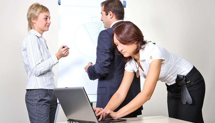 Photo Credit: Three office workers image by Vladimir Melnik from <a href='http://www.fotolia.com'>Fotolia.com</a> Survey your employees.