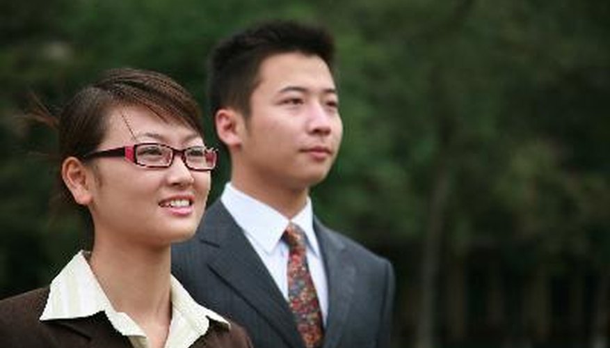 Photo Credit: Asian business people image by huaxiadragon from <a href='http://www.fotolia.com'>Fotolia.com</a> Asian agents can simplify textile trading for American retailers.