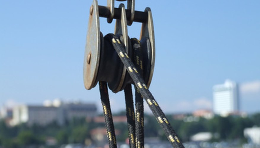 Photo Credit: pulley of a boat image by timur1970 from <a href='http://www.fotolia.com'>Fotolia.com</a> You can calculate the work efficiency of a machine such as a pulley.
