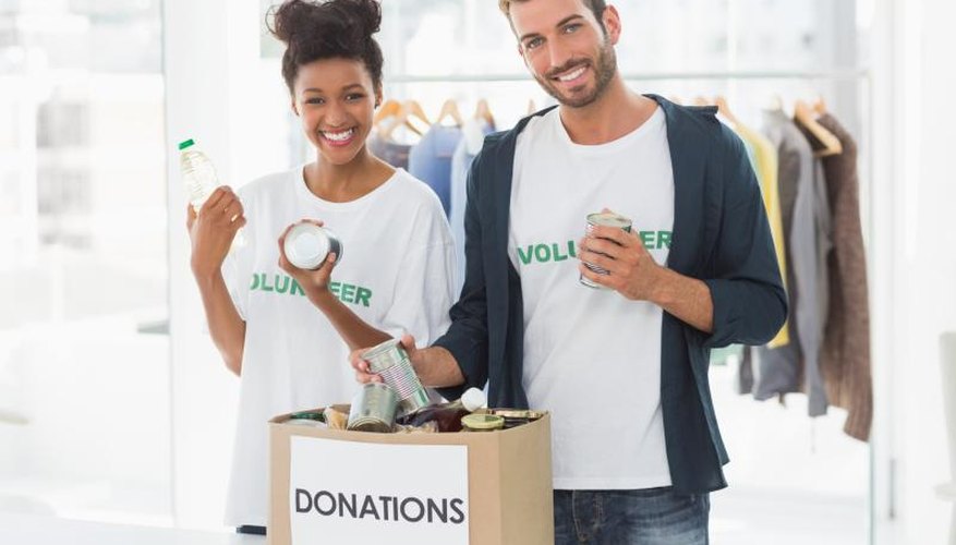 Volunteers holding a donation box.