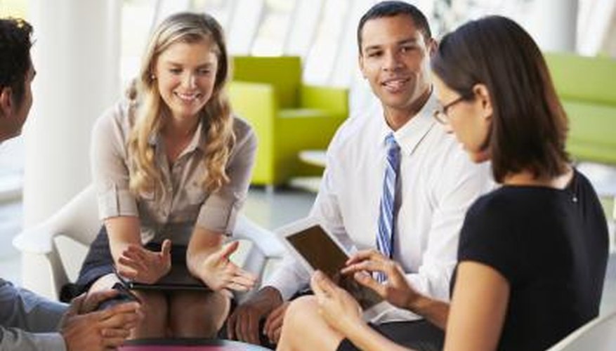 Photo Credit: Monkey Business Images Ltd/Monkey Business/Getty Images adults discussing kindergarten