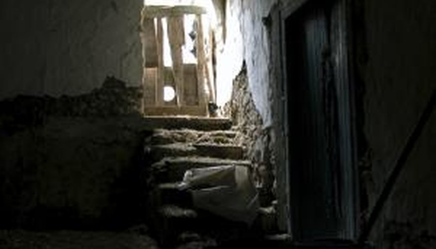 Remove the walls and flooring to gut an old basement. Remove the walls and flooring to gut an old basement.