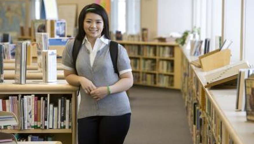 Smiling high school student in library