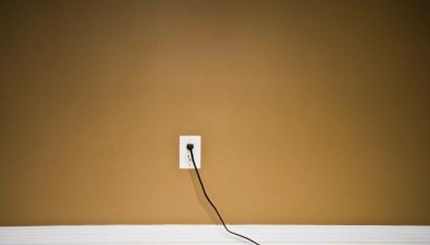Photo Credit: Jupiterimages/Photos.com/Getty Images Electrical cord in socket.