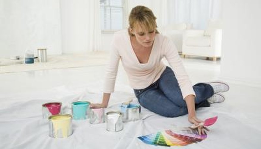 Woman looking at several paint swatches. Woman looking at several paint swatches.
