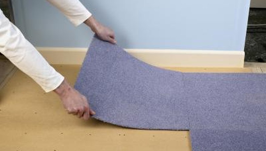A man installs carpet A man installs carpet