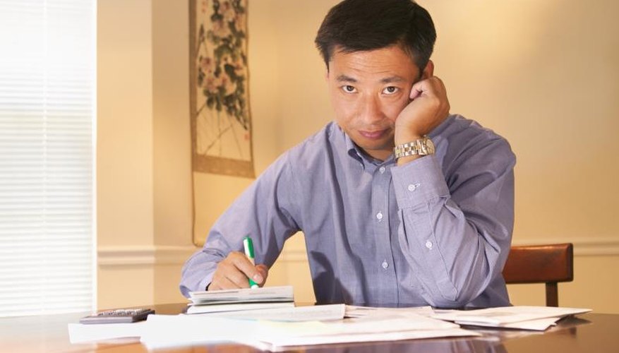 Man with bills and checkbook